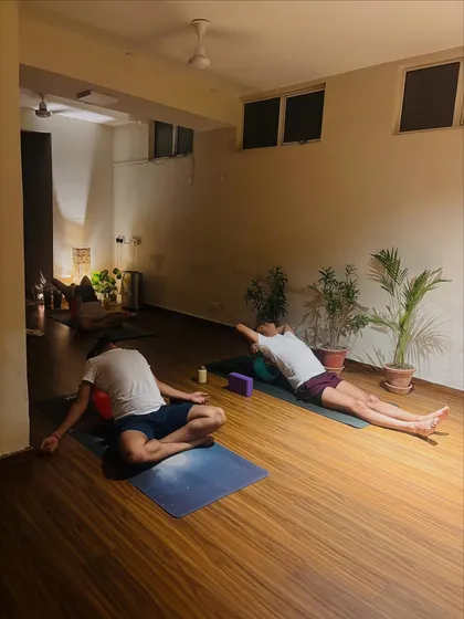 After a strong practice, the body finds deep rest. Here, students are in shavasana, allowing the nervous system to settle and absorb the benefits of their efforts.
