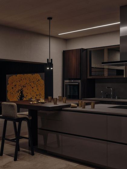 Another angle of the kitchen, showing the integration of the oven and the warm glow of a painting in the background. The design is both highly functional and aesthetically pleasing.