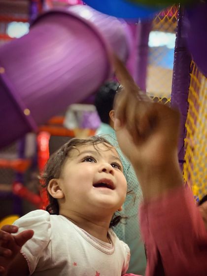 A moment of wonder for this sweet baby looking up from the play area. Our space is designed to be engaging and captivating for all ages.