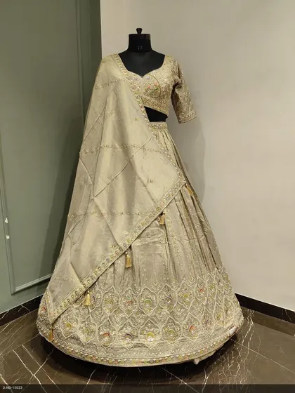 This elegant beige lehenga on the mannequin showcases the detailed embroidery and the beautiful fall of the fabric. It's a timeless piece for a bride or bridesmaid.