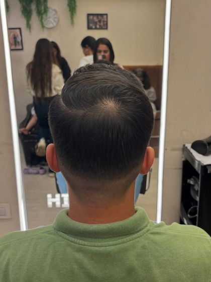 The back view of a classic men's haircut with a clean taper fade, a timeless and sleek look.