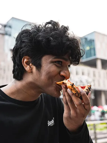 A guest takes a satisfying bite of our pizza at the Sunday Soul Sante event. We love being part of Bangalore's vibrant community gatherings.