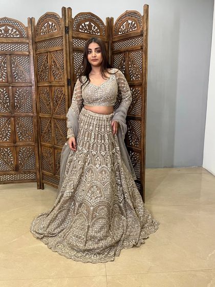 A full-length view of another gorgeous grey lehenga. This pre-loved piece features heavy, all-over embroidery, making it a luxurious option for a reception or special event.