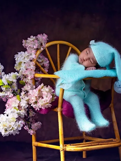 Using the same chair prop, I created a completely different look with a cozy blue knit outfit and delicate floral accents. This demonstrates how I can customize themed setups to create varied looks.