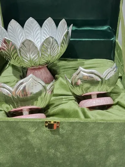 This is one of my favorite creations, a set of three lotus-shaped German silver bowls presented in a luxurious velvet box. The dual-tone finish and delicate craftsmanship make this a perfect heirloom gift for weddings, housewarmings, or any special milestone.