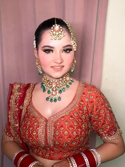 The full bridal look, complete with a floral bun and a beautiful smile.