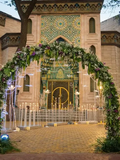 Your guests' first impression starts at the entrance. For this elegant event, we designed a magnificent floral archway, complemented by glowing lotus installations and illuminated birds, creating a magical pathway into the celebration.