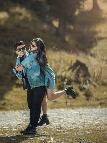 A fun piggyback ride in a mountain meadow. This playful and joyful shot is perfect for showing a couple's fun-loving personality.