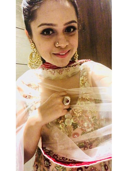 A closer look at the details of this embroidered pastel suit. The combination of the choker-style neckline, statement earrings, and dewy makeup completes this monotone wedding guest look.