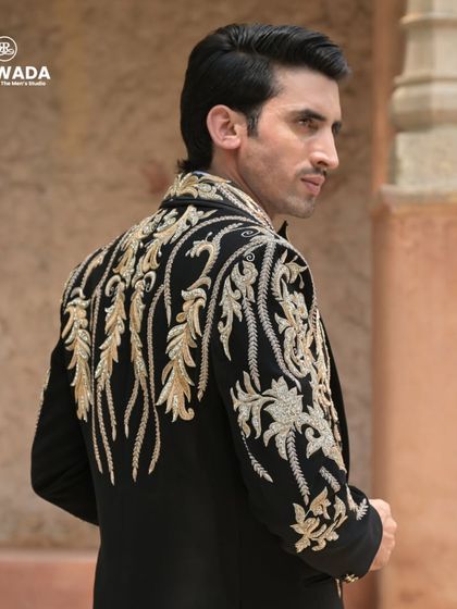 A view of the back of the baroque tuxedo jacket, showing how the lavish embroidery continues around the entire piece for a 360-degree impact.