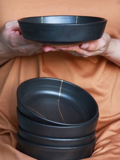 The 'Celebrations' collection by Bhavisha Desai, featuring elegant black pasta bowls with delicate gold kintsugi style lines, designed to elevate every meal.