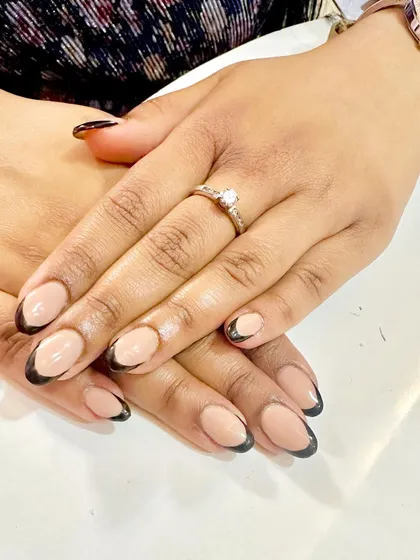 A bold and graphic twist on the French manicure. I used a sharp black tip on a natural base for a modern, high-contrast look on these short, elegant nails.