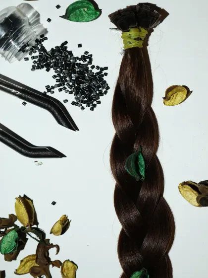 This image showcases the art of creating volume. You can see a thick braid of 100% human hair next to the tiny keratin beads and tools I use for a flawless application.