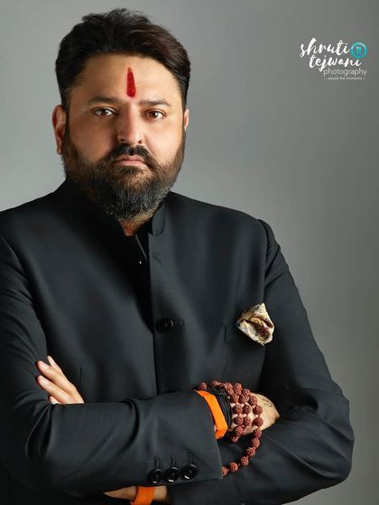 A strong and serious portrait for business leader Mohit Bharatiya. This classic headshot against a simple grey background conveys authority and confidence.