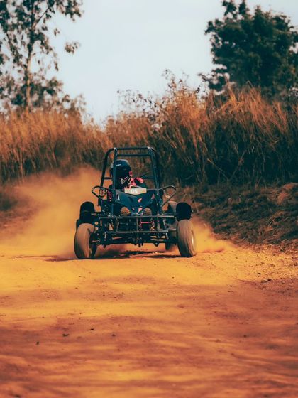 A head-on shot of a dirt kart racing down the track. Are you ready to get behind the wheel?