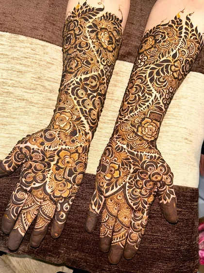 A beautiful example of a heavy Indo-Arabic design with a mix of floral, paisley, and geometric patterns creating a rich tapestry on the hands and arms.