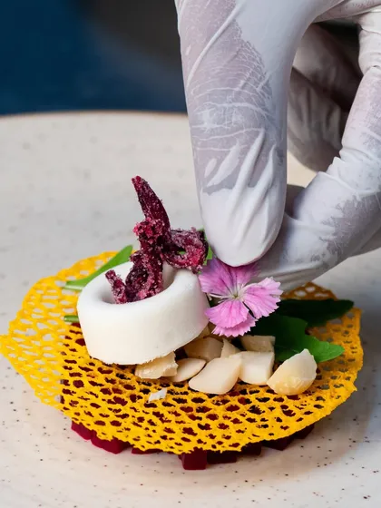 Culinary art is in the details. This image captures the final touch on a meticulously plated appetizer, showcasing our focus on precision, fresh ingredients, and beautiful presentation that makes every bite a masterpiece.