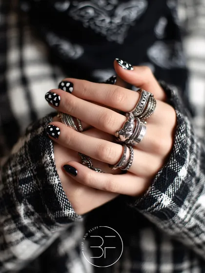For a more edgy take on polka dots, this design pairs a black and white plaid pattern with bold, contrasting polka dot nails.