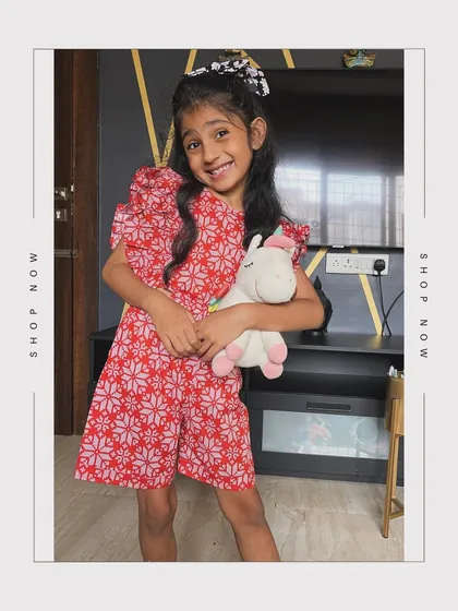 Unveil playful elegance with our red printed jumpsuit. It has a sweet cut-out at the waist and charming frill detailing on the sleeves, tailor-made for your little one’s play dates.