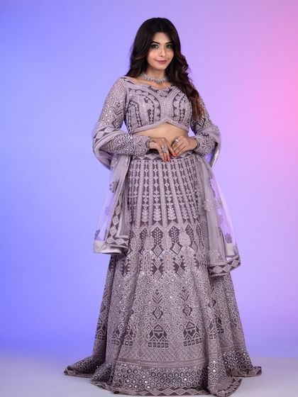 A full-length shot of the lilac lehenga, showing the complete outfit with its detailed embroidery and flowing skirt. A true statement piece.