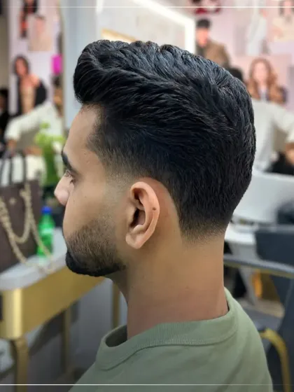 A perfect example of a clean, classic men's haircut. This style features a seamless taper fade on the sides and back, with just enough length on top for versatile styling.