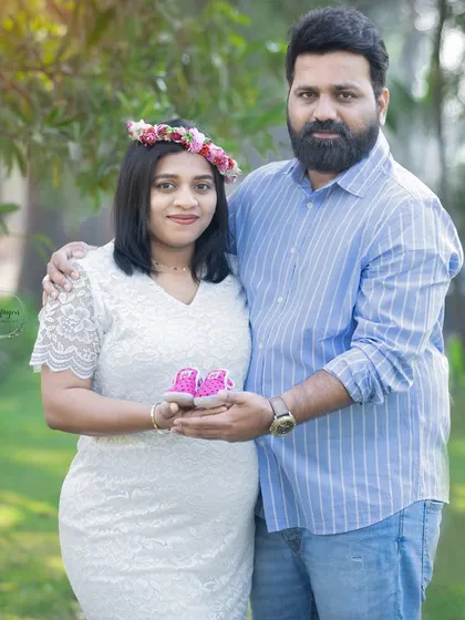 Together, holding the promise of their baby girl. This couple's portrait, featuring tiny pink shoes and a floral crown, is a perfect blend of sweetness and anticipation.