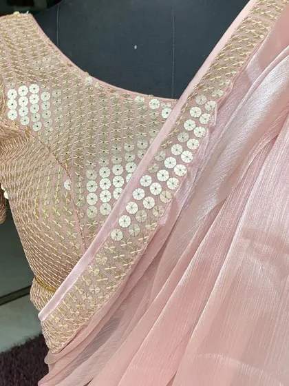 A close up of the 'Gulabi' saree with its matching sequin blouse. The craftsmanship ensures a perfect fit and a flawless look.