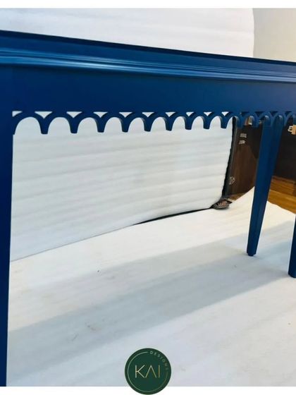 A striking blue console table with intricate arch-cut details along the apron. This piece demonstrates our precision woodworking and ability to execute bold, colorful designs.
