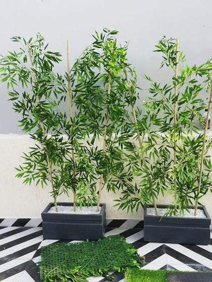 As part of the terrace decor, we provided these realistic artificial bamboo plants in modern black planters. They add a touch of green without requiring any maintenance.