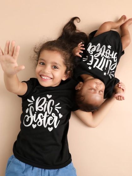 Big Sister, Little Sister. This adorable aerial shot with matching t-shirts is such a fun and creative way to capture the special bond between siblings.