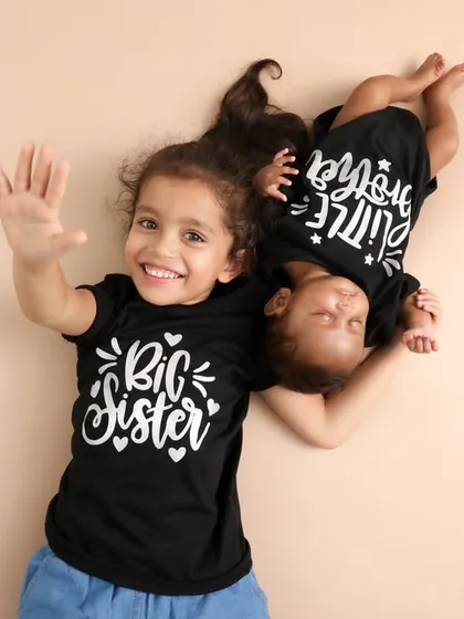 Big Sister, Little Sister. This adorable aerial shot with matching t-shirts is such a fun and creative way to capture the special bond between siblings.