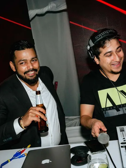 A candid moment behind the decks. It’s not just about playing music; it’s about sharing the fun and creating a friendly, energetic atmosphere.