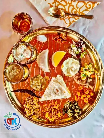 While I specialize in traditional banana leaf service, I can also provide elegant plated meals. This beautiful brass thali setting is perfect for receptions and corporate events where you want a more formal dining experience.