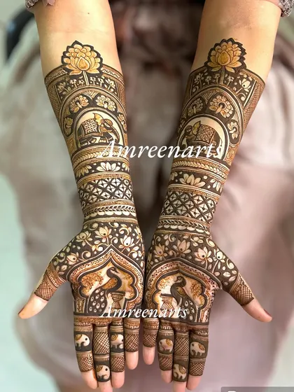 A regal design featuring elephants and peacocks within ornate arches, giving the hands a majestic and traditional look.