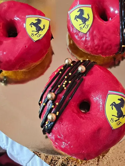 Bright red donuts with the Ferrari logo.