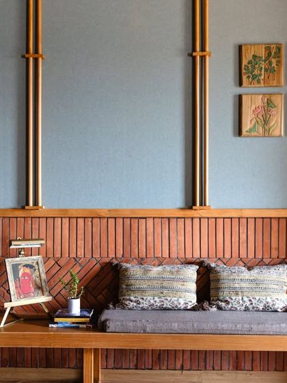 A seating nook within the boardroom, showcasing the detailed brickwork and teakwood spindles. This space provides a comfortable breakout area while maintaining the room's sophisticated, acoustically optimized design.