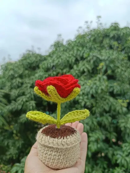 A single potted red rose, a timeless classic handmade with care.