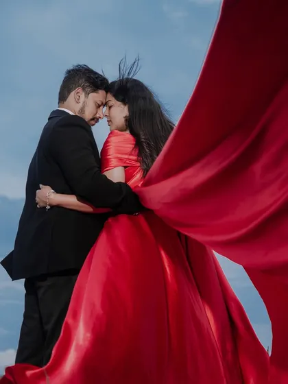 A dramatic and artistic pre-wedding photo. We love getting creative with concepts, using elements like flowing fabrics and stunning landscapes to create fine art portraits you'll treasure forever.