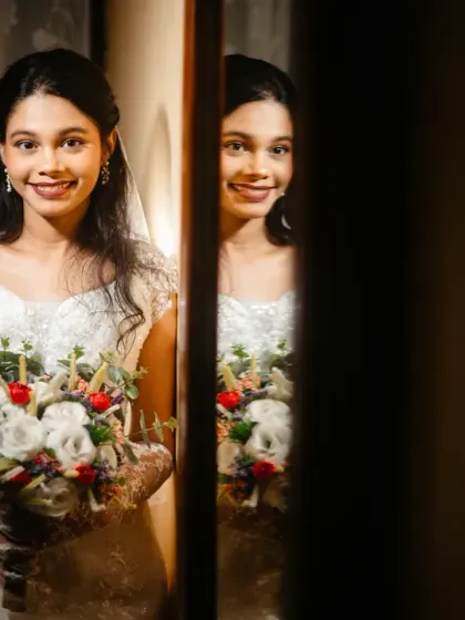 A simple, sweet, and elegant bridal portrait, with the bride's reflection adding depth to the image.