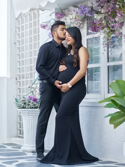 Timeless, elegant, and always in style. A classic black gown is a sophisticated choice for your maternity shoot, creating a chic and modern look against our floral studio backdrops.