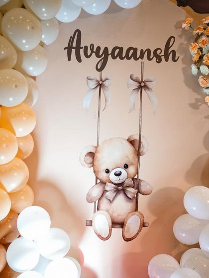 A cute teddy bear graphic on a backdrop, personalized with the baby's name. This is a simple way to add a custom touch to any party theme.