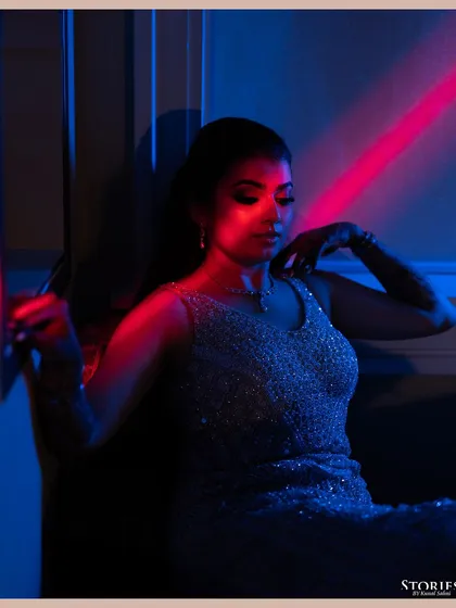 An artistic portrait of the bride, Kritika, using colored gels to create a modern and vibrant look for her cocktail party.