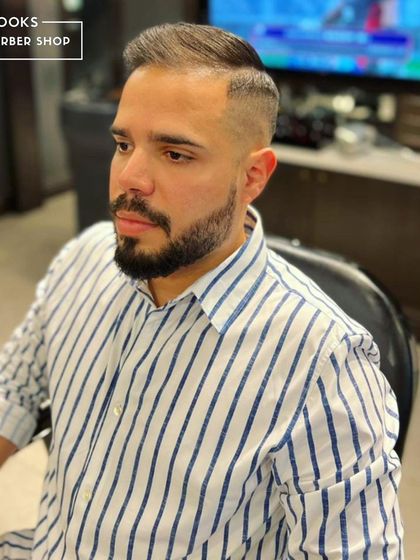 Another view of this sharp, contemporary haircut. The seamless fade and precise lines demonstrate our attention to detail in every cut we perform.