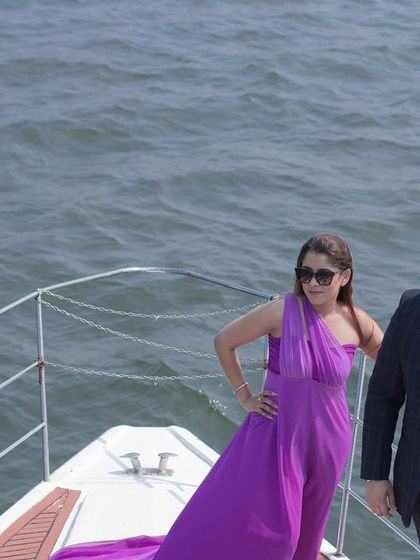 A fashionable shot of the couple on the bow of a yacht in Goa, showcasing a modern and luxurious pre-wedding experience.