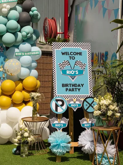 A personalized welcome sign for Rio's racing party, designed to look like a collection of road signs. It's a fun and creative way to greet guests.
