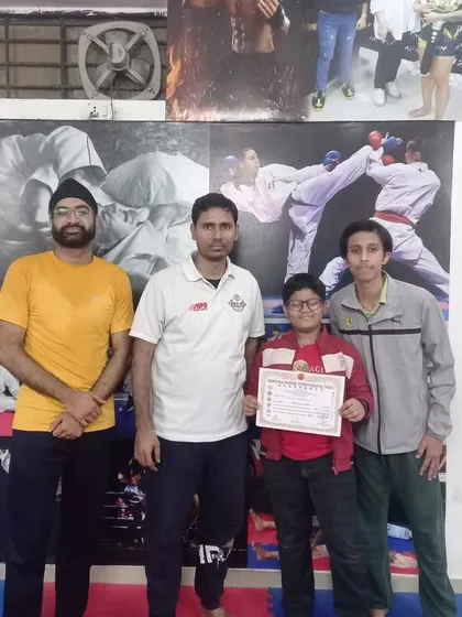 A student receiving his certificate and medal at the academy. We celebrate every achievement on the path of martial arts.