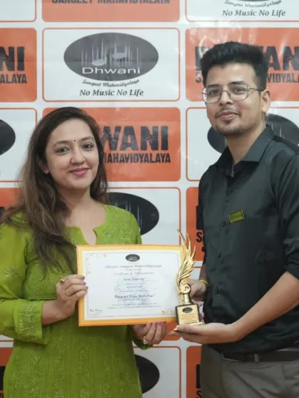 An adult student receives her award, showing that it's never too late to pursue art.