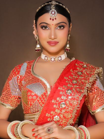 The full view of a traditional bridal look, showcasing the perfectly draped dupatta and coordinated jewelry, all part of the comprehensive training.