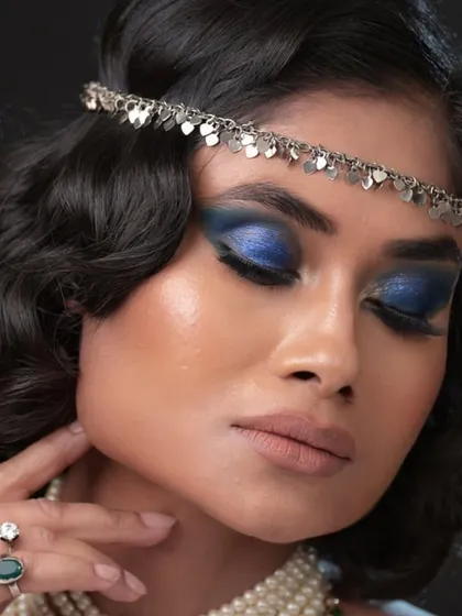 A close-up with eyes closed to show the beautiful shimmer and blend of the blue eyeshadow.