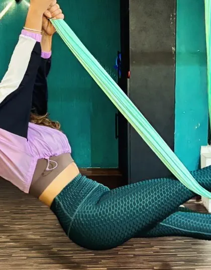 Here, I am demonstrating a suspended side plank variation using the aerial hammock. This pose intensely engages the obliques and improves balance, showing how the silks can add a new level of challenge to familiar exercises.